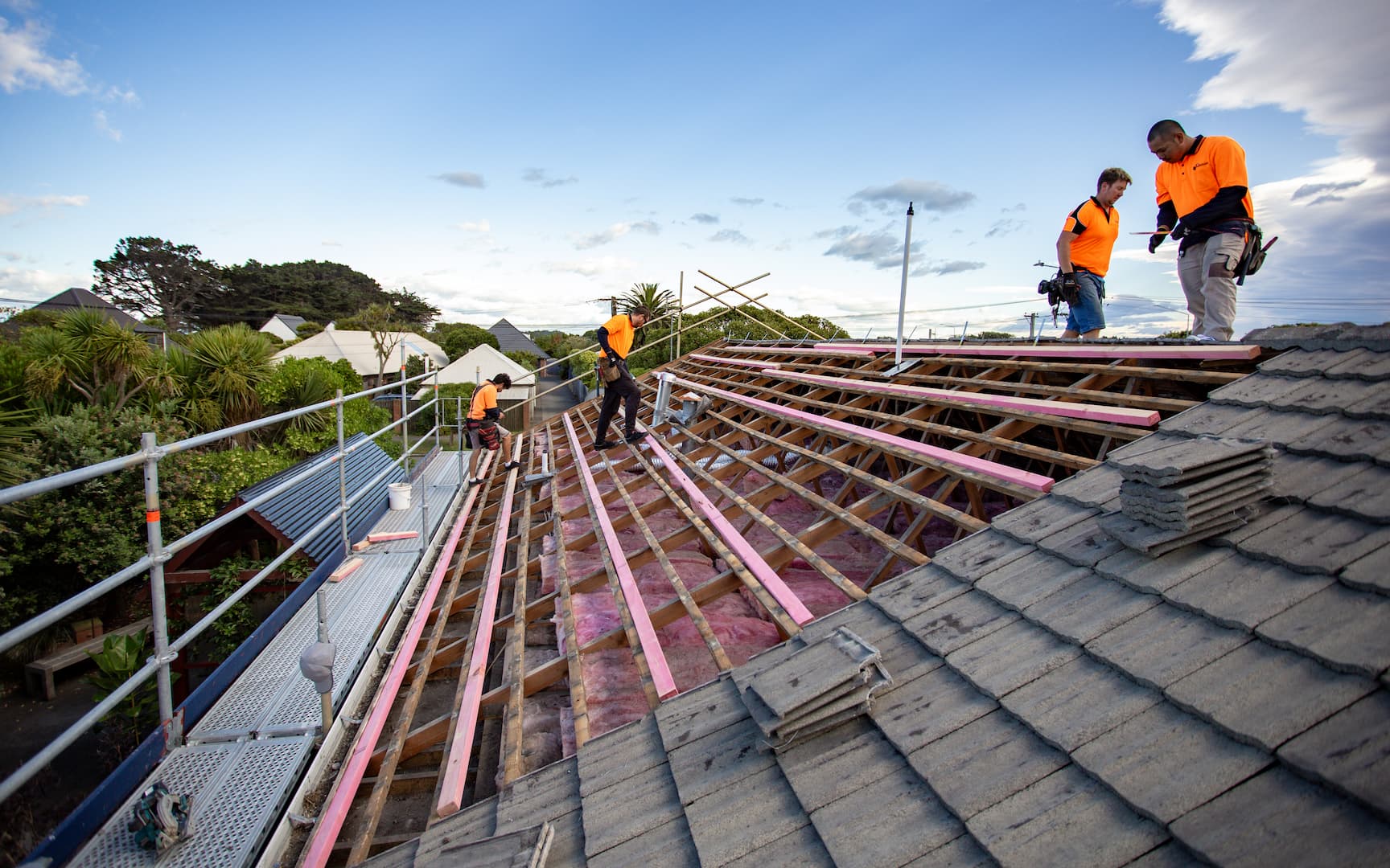 Workers installing roofing on a house: Skilled laborers diligently working on roof installation.